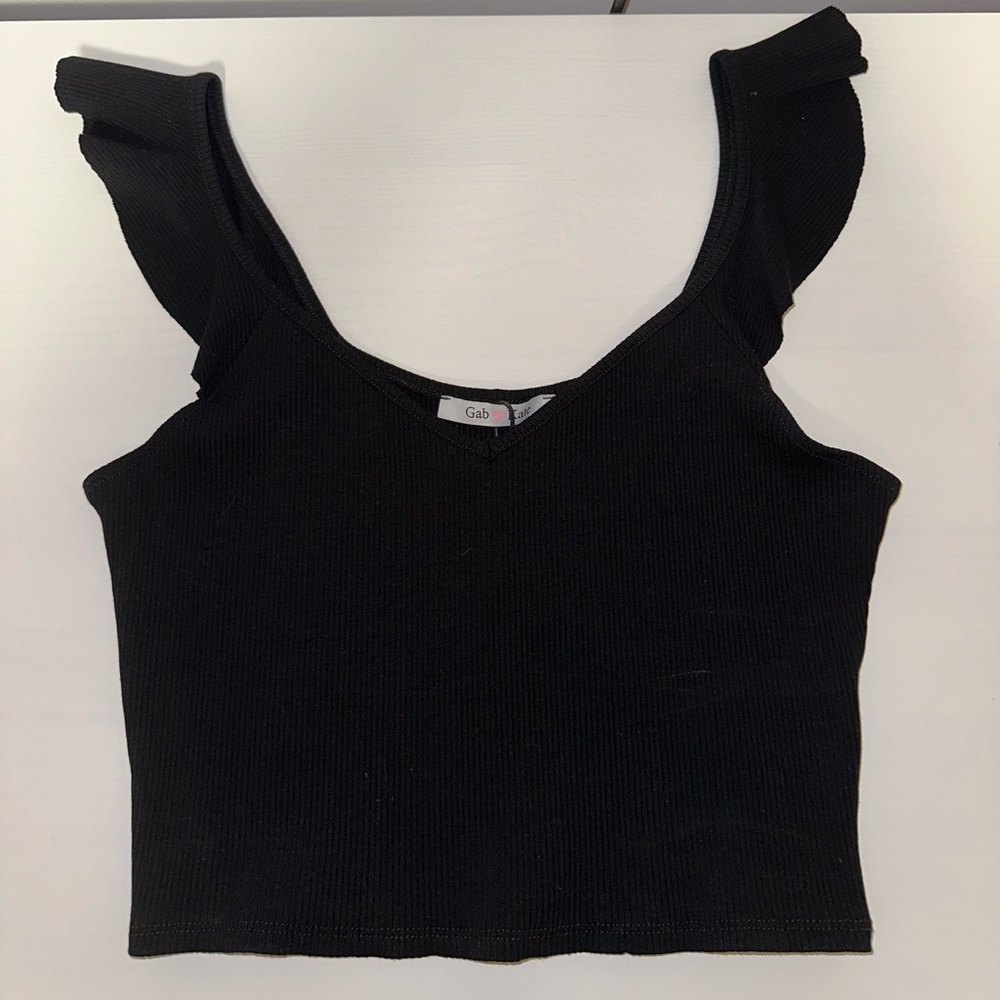 Black ruffle sleeve tank top. Ribbed material. New with tags. Never worn.